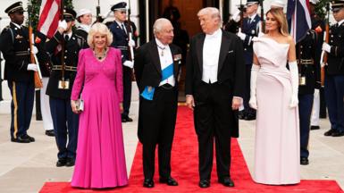 Queen Camilla, King Charles III, U.S. President Donald Trump, and First Lady Melania Trump pose at the base of the Grand Staircase during an official state dinner hosted by the President and First Lady at The White House on day two of the State Visit
