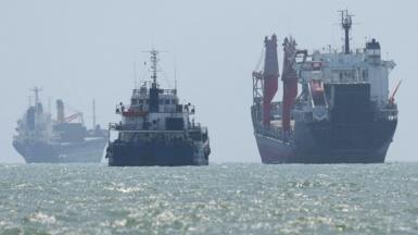 Vessels in the Strait of Hormuz are visible near the beach of Bandar Abbas, Iran, August 25, 2026