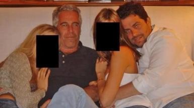 Brett Ratner and Jeffrey Epstein embrace women as they sit on a sofa together in an undated photo
