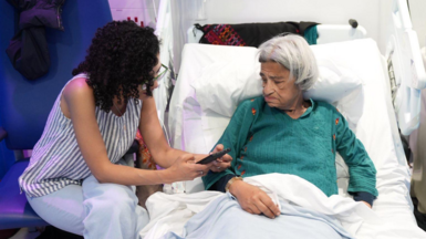 Sanaa Seif (L) sits beside her mother Laila Soueif (R) at St Thomas' hospital, London
