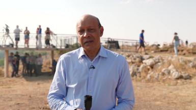Pallab looking at the camera, several people visible behind him