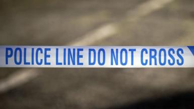 Police tape reads "Police line do not cross" 