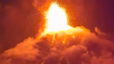Orange lava erupts into the night sky
