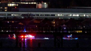 Emergency response units conduct search and rescue operations in the Potomac River near Ronald Reagan Washington Airport on January 29, 2025 in Arlington, Virginia.