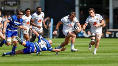 Ethan Burger (right) skips past Tom Dunn's tackle on the floor 