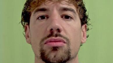 Police mugshot of Kane Jones, who has brown hair and a goatee.