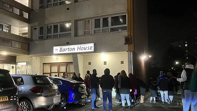 People stood outside of tower block