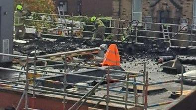 Fire extinguished on the roof of a building - Beighton Health Centre in Sheffield - with fire crews working at the scene