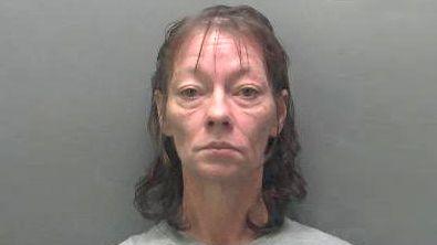 A police custody image of Anne-Marie Burrowes. She has long black hair.