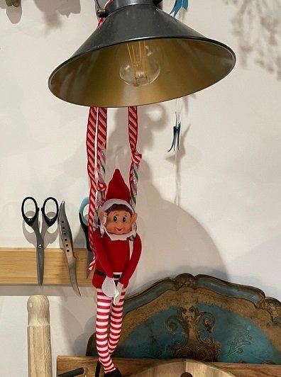 elf hanging off a light