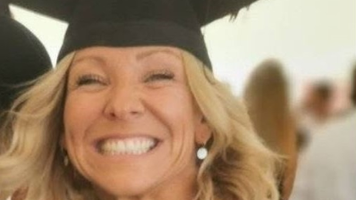 Claire Chick, wearing a graduation cap and smiling.