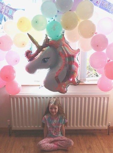 Lucy celebrated her birthday in beautiful rainbow style with a spectrum of colourful balloons and a unicorn to match!