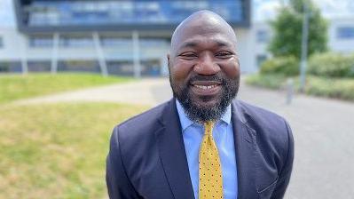 Conservative Candidate Festus Akinbusoye in a dark blue suit, light blue shirt and yellow tie