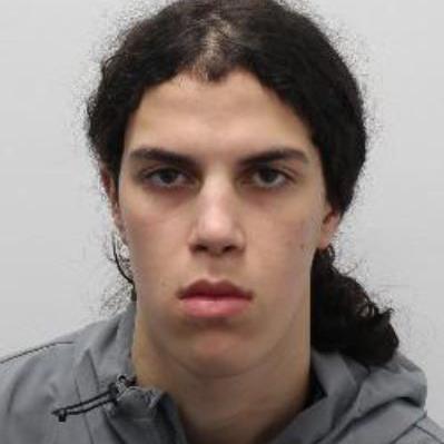 Mugshot of Zachariah Boulares. He is seen from the shoulders up wearing a grey hoodie and staring directly at the camera.