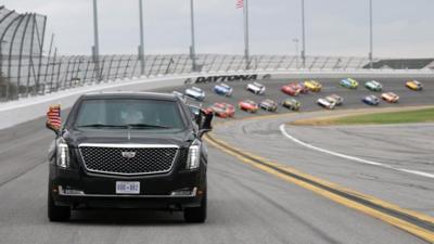 President Trump's motorcade leads racing cars around Daytona circuit banking