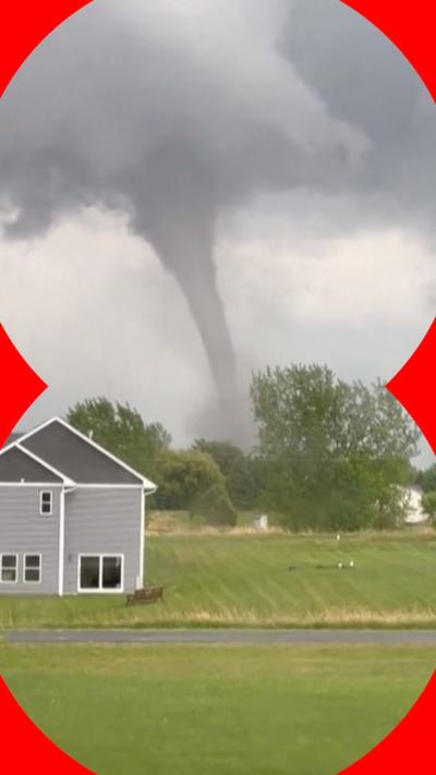 Tornado seen next to house - it rises up from the ground forming a huge cloud 
