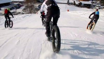 Bikers brave ice and snow for a high-speed race through the Swiss mountains.