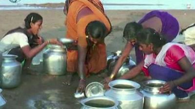 Indian women collecting water