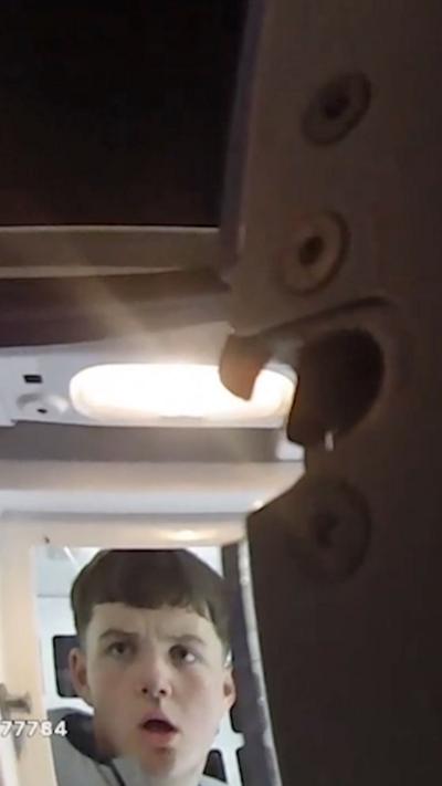 Marcus Staniforth can be seen sitting in the back of a police van.