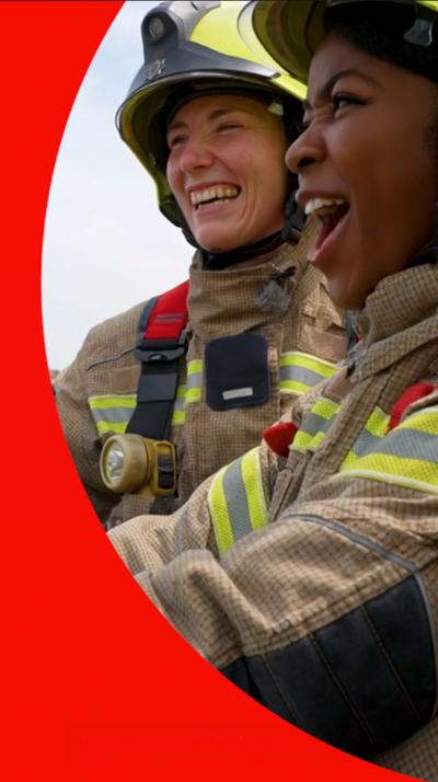 Rugby player Jade Konkel in firefighters uniform smiling with a Newsround reporter
