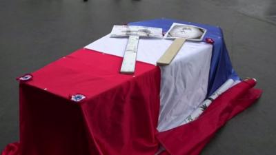 A mock coffin is seen at the police protest in Paris