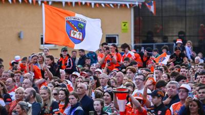 Armagh GAA fans, holding up the Armagh GAA flag.