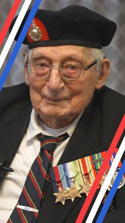 Older man sitting in chair, wearing a tie, jacket and beret along with multiple war medals