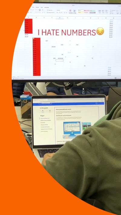 Screengrab of the video, where a computer screen has Excel open with the text 'I hate numbers' and a sad emoji