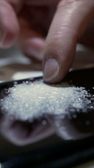 A small amount of white powder on a black screen.