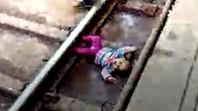 Baby on train tracks