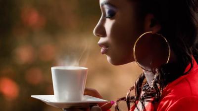 woman smelling coffee