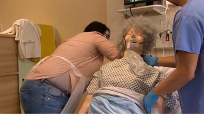 Staff practising with a dummy patient