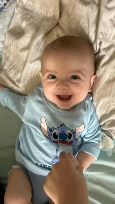 Baby Jensen-Lee Dougal smiling at the camera