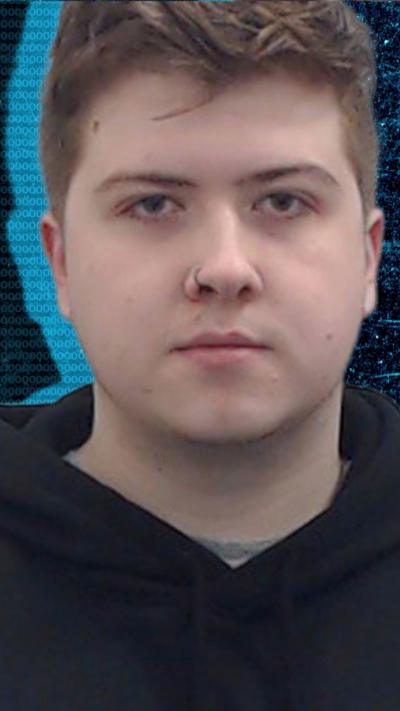 A youngish man with brown hair spiked up at the front. 