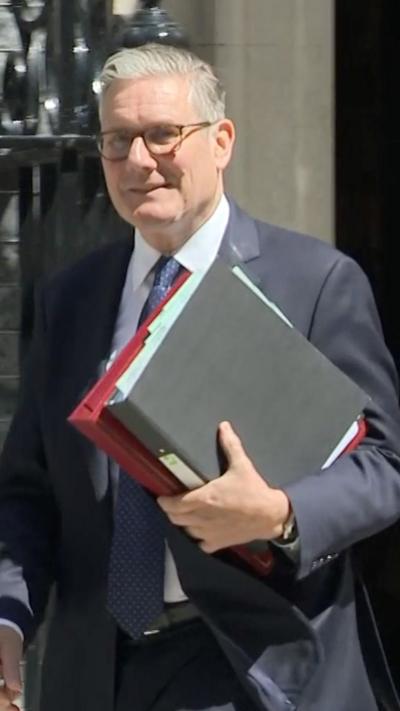 Starmer holds folders as he leaves No 10