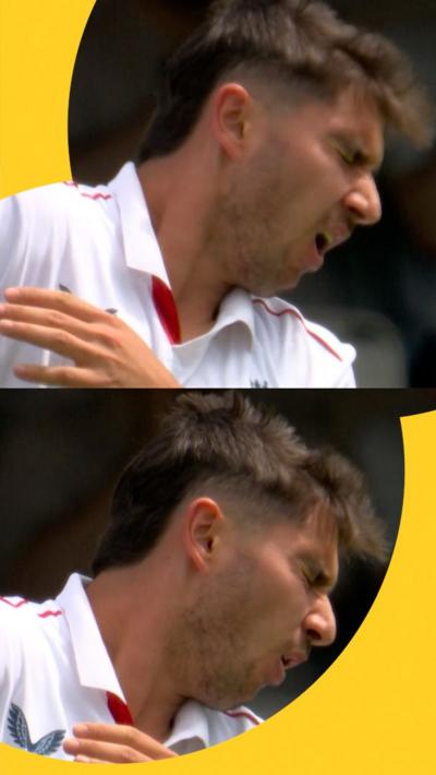 England's Josh Tongue reacts to getting hit in the face with ball