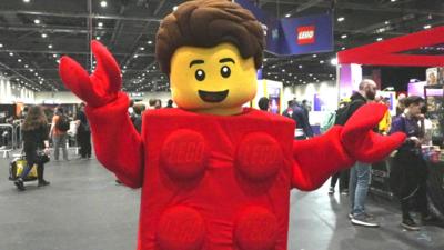 A person dressed in a Lego costume, with their body as a Lego brick