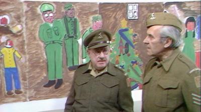 Arthur Lowe and John Le Mesurier dressed in army uniforms in front of a child's illustration.