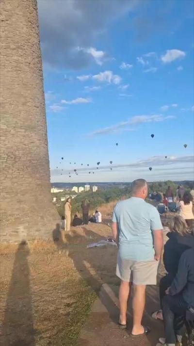 Man stood watching balloons