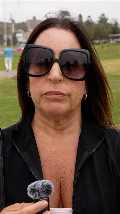 Woman with dark hair wearing large sunglasses 