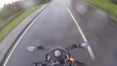 Video of a motorcyclist speeding.