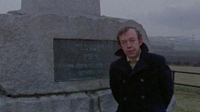 Phil Tibenham stands beside the Flodden battlefield monument