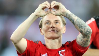 Jess Fishlock salutes fans with hand symbol