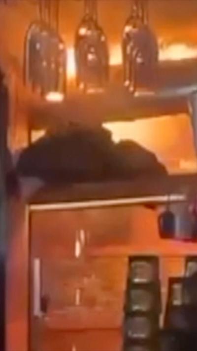 Flames on the ceiling of a dark bar