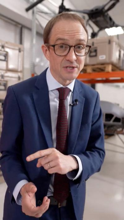 Chris Mason wearing a suit and tie