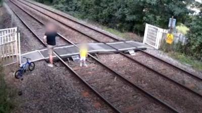 CCTV footage shows people behaving 'recklessly' on level crossing