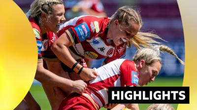 Wigan players celebrate scoring a try