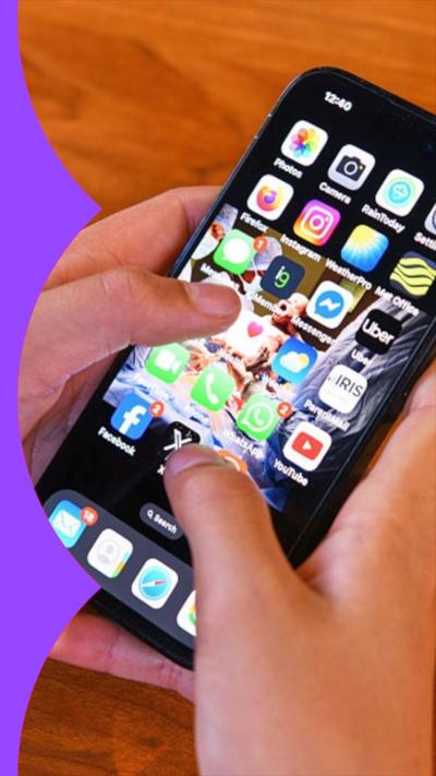A teenager's hands holding a phone with lots of apps on the screen.