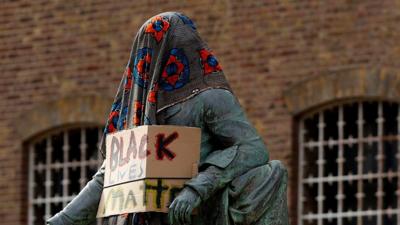 Statue of Robert Millagan with Black Lives Matter sign