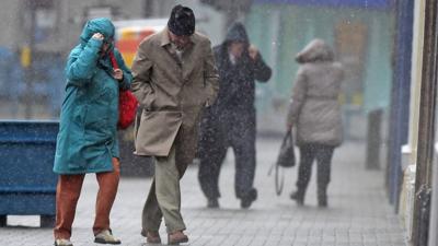 People walking in a storm